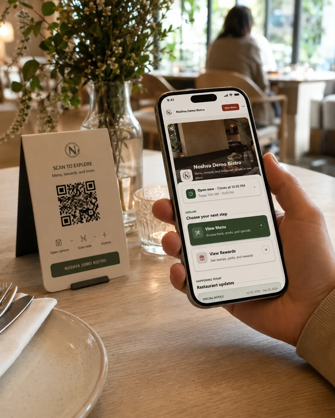 A guest opening the Noshva QR Landing from a restaurant table