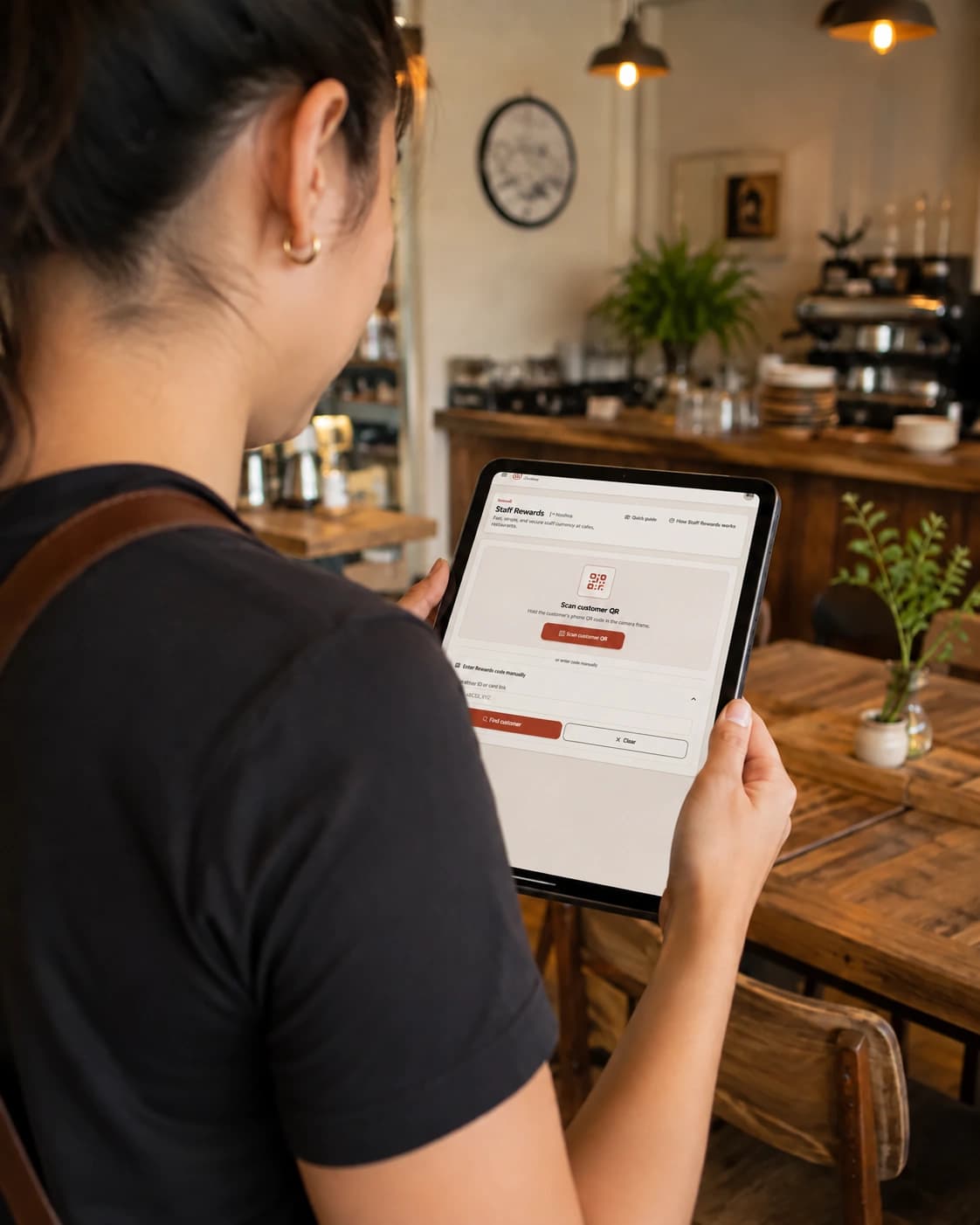 Restaurant employee using the Noshva Staff Rewards on a tablet behind the counter