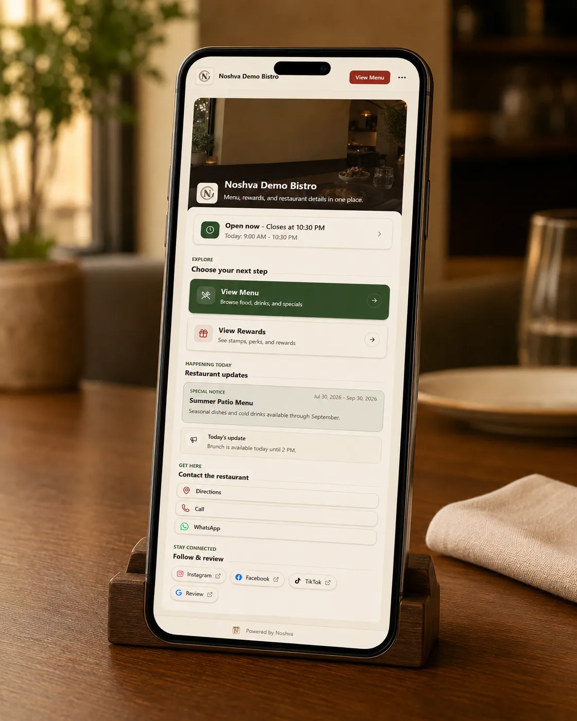 Noshva Demo Bistro mobile landing page shown in a restaurant setting.