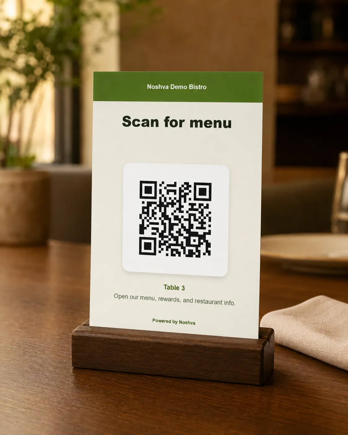 Printed Noshva Demo Bistro QR card displayed on a restaurant table.
